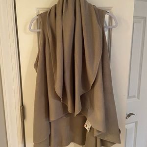 NWT. Tan sleeveless cardigan. O/S.